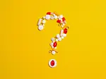 Pills and capsules on a yellow background