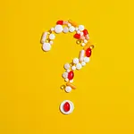 Pills and capsules on a yellow background