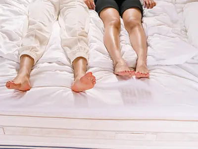 Couple laying next to each other on a bed